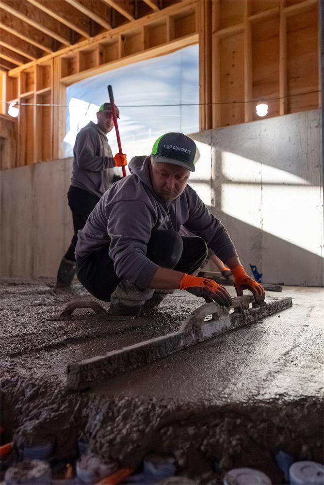 Concrete Master crew finishing a basement floor pour, Richmond Hill