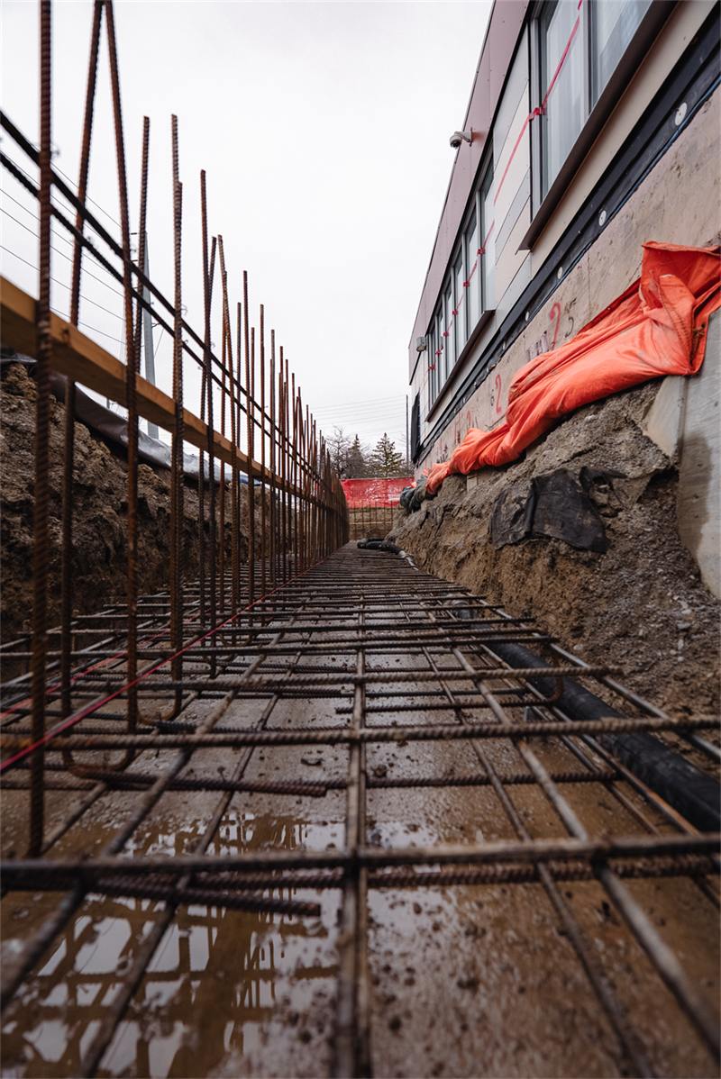 Reinforcement mat laid down the length of a footing before a pour