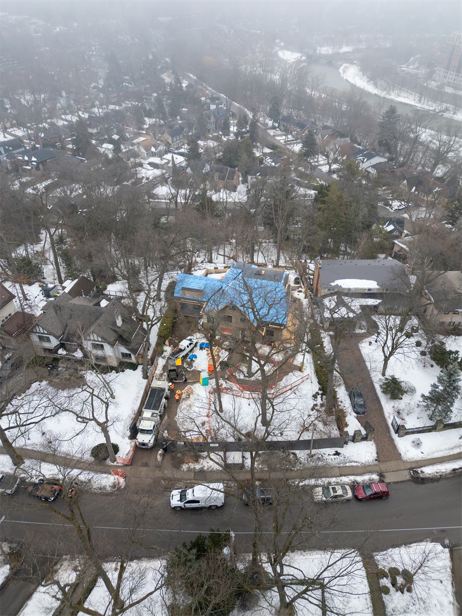 Aerial view of a home addition under construction in winter