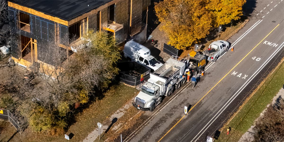 Aerial view of concrete pump and mixer trucks on a commercial job site
