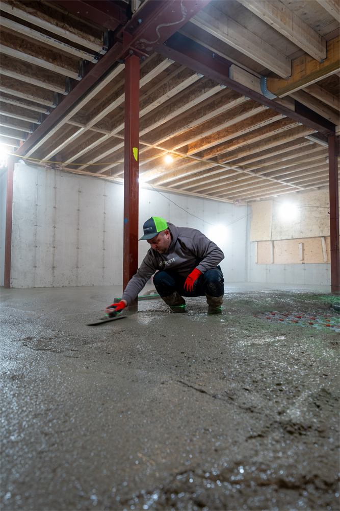 Crew finishing a basement slab pour, Baby Point, Toronto