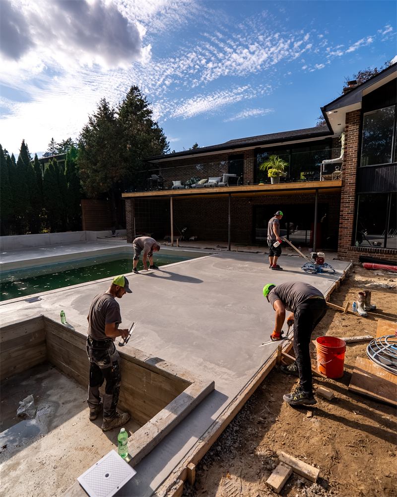 Crew finishing a large pool deck slab, Mississauga